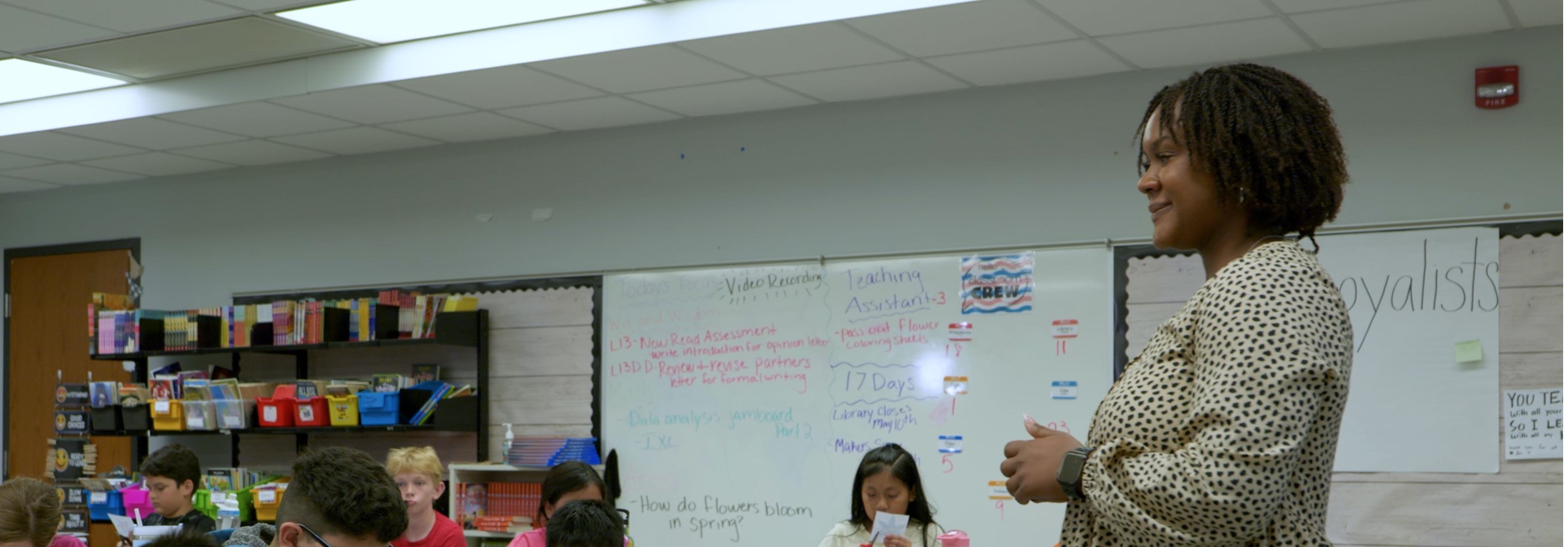 a teacher giving a thumbs up to students