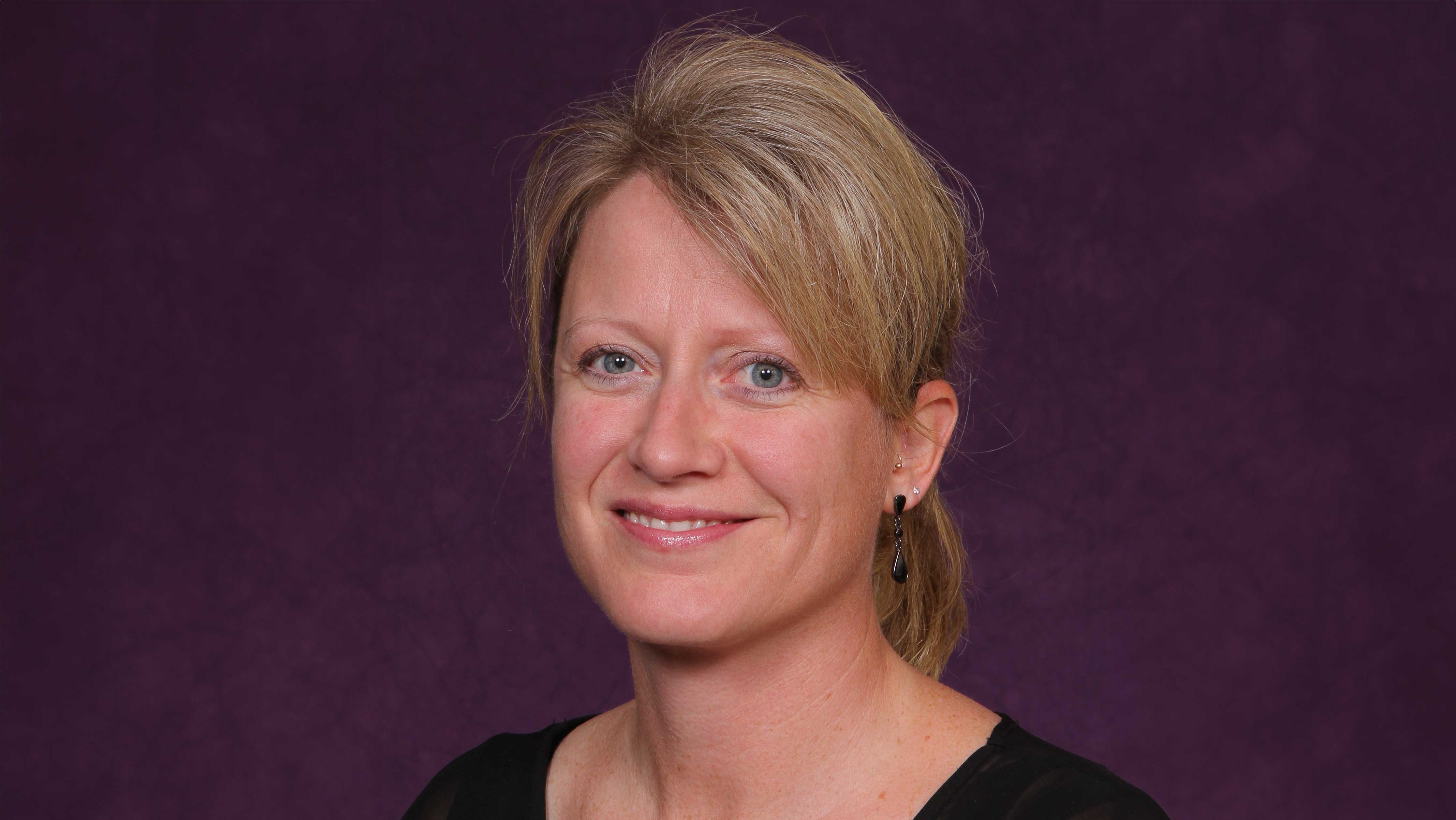 a person with blonde hair wearing a black shirt