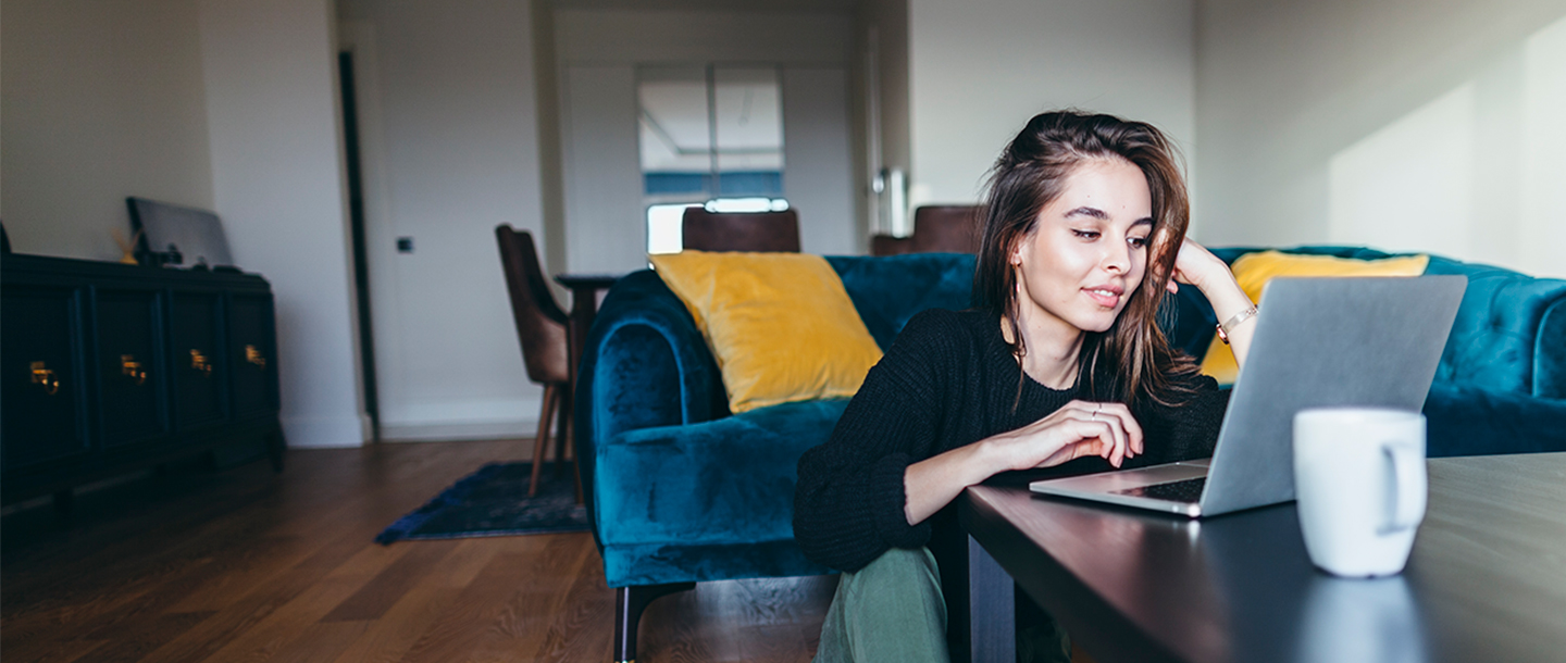 a person sitting at a table using a laptop